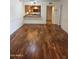 Open living room featuring wood floors and a view of the kitchen at 10330 W Thunderbird Blvd # C-228, Sun City, AZ 85351