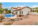 Enjoy the backyard's sparkling pool, fire pit, and a comfortable seating area under a pergola, perfect for relaxing and entertaining at 10775 N 101St St, Scottsdale, AZ 85260
