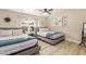 Bedroom featuring two beds with gray frames and decorative accents, illuminated by a ceiling fan at 10775 N 101St St, Scottsdale, AZ 85260