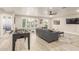 Spacious living room featuring a foosball table, comfortable seating, and a mounted television at 10775 N 101St St, Scottsdale, AZ 85260