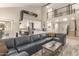 Open-concept living space with a modern sectional sofa and contemporary design elements at 10775 N 101St St, Scottsdale, AZ 85260