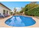 Relax and enjoy the backyard pool featuring mature desert landscaping and a patio with lounge seating at 10775 N 101St St, Scottsdale, AZ 85260