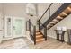 Modern staircase with wooden treads, black metal railings, and a contemporary aesthetic at 10775 N 101St St, Scottsdale, AZ 85260