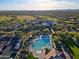 This aerial shot reveals a community pool with mountain views and parking at 32868 N 69Th St, Scottsdale, AZ 85266