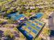 Aerial view features community tennis and pickleball courts nestled among desert landscaping and homes at 32868 N 69Th St, Scottsdale, AZ 85266