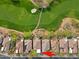 High-angle aerial shot reveals home's positioning along the golf course with mountain backdrop at 32868 N 69Th St, Scottsdale, AZ 85266