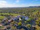 Aerial view of a large community building, golf course, and residences at 32868 N 69Th St, Scottsdale, AZ 85266