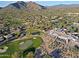 Beautiful aerial view showcasing the golf course, houses and desert landscape in this golf community at 32868 N 69Th St, Scottsdale, AZ 85266