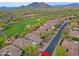 Beautiful aerial view showcases this home's prime location next to a lush golf course and mountain backdrop at 32868 N 69Th St, Scottsdale, AZ 85266