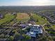 Expansive aerial view of the community with a golf course and a large building complex at 32868 N 69Th St, Scottsdale, AZ 85266