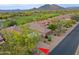 Aerial view of desert-landscaped property with mature trees, and desert landscaping near a golf course at 32868 N 69Th St, Scottsdale, AZ 85266