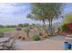 Back patio with desert views, mature trees, metal railing, and an outdoor dining area at 32868 N 69Th St, Scottsdale, AZ 85266