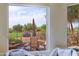 Backyard view showcasing patio seating, golf course, desert landscaping, and beautiful desert sky at 32868 N 69Th St, Scottsdale, AZ 85266