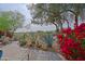 Relaxing backyard featuring desert plants, flowers, and a well-manicured golf course at 32868 N 69Th St, Scottsdale, AZ 85266
