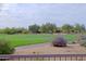 Serene backyard view overlooking a lush golf course with mature trees at 32868 N 69Th St, Scottsdale, AZ 85266