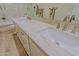 Bathroom featuring double sinks, light countertops, white cabinets, and wood-look tile flooring at 32868 N 69Th St, Scottsdale, AZ 85266