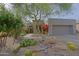Charming desert landscaping with river rock features a stone pathway to the front door at 32868 N 69Th St, Scottsdale, AZ 85266