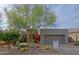 Charming single-story home features desert landscaping, mature trees, and a two-car garage at 32868 N 69Th St, Scottsdale, AZ 85266
