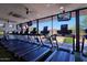 Modern gym showcases treadmills with individual screens, surrounded by windows with scenic views at 32868 N 69Th St, Scottsdale, AZ 85266