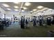 Spacious gym features modern exercise equipment, ample lighting, and a view of the surrounding landscape at 32868 N 69Th St, Scottsdale, AZ 85266