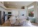 Well-lit kitchen with white cabinets, stainless steel appliances, and a spacious island with seating at 32868 N 69Th St, Scottsdale, AZ 85266