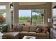 Living room with large windows overlooking the lush golf course at 32868 N 69Th St, Scottsdale, AZ 85266