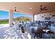 Spacious covered patio with multiple seating areas, overlooking the golf course and mountains at 32868 N 69Th St, Scottsdale, AZ 85266