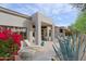 Covered patio with outdoor seating, desert plants, and serene golf course scenery at 32868 N 69Th St, Scottsdale, AZ 85266