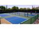 Outdoor pickleball court featuring players and a desert backdrop with mature trees and rock landscaping at 32868 N 69Th St, Scottsdale, AZ 85266