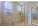 Modern tile shower with seamless glass door, bench, and niche at 32868 N 69Th St, Scottsdale, AZ 85266