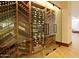 Climate-controlled wine cellar with wooden racks and glass doors, showcasing an extensive collection at 32868 N 69Th St, Scottsdale, AZ 85266