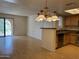 Spacious living area with breakfast bar connected to kitchen, and backyard access at 5757 W Eugie Ave # 1038, Glendale, AZ 85304