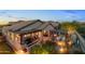 Stunning aerial view of backyard with outdoor living areas, fire pit, and mountain views at 6887 E Hacienda La Colorada Dr, Gold Canyon, AZ 85118