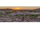 Scenic sunset view over the community with desert landscaping and mountain views at 6887 E Hacienda La Colorada Dr, Gold Canyon, AZ 85118