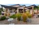 Landscaped backyard with stone, artificial turf, grill, and covered patio at 6887 E Hacienda La Colorada Dr, Gold Canyon, AZ 85118