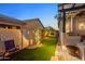 Backyard featuring putting green, custom lighting, privacy wall and built-in BBQ at 6887 E Hacienda La Colorada Dr, Gold Canyon, AZ 85118