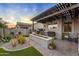Back patio with outdoor kitchen, artificial turf, and covered structure at 6887 E Hacienda La Colorada Dr, Gold Canyon, AZ 85118