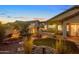 Backyard with built in BBQ, lush desert plants and water feature at 6887 E Hacienda La Colorada Dr, Gold Canyon, AZ 85118