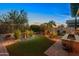 Beautiful backyard featuring a water feature, synthetic lawn, and manicured landscaping at 6887 E Hacienda La Colorada Dr, Gold Canyon, AZ 85118