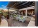 Outdoor living area with pergola-covered patio, seating, and brick pavers at 6887 E Hacienda La Colorada Dr, Gold Canyon, AZ 85118