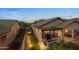 Aerial view of a backyard with a covered patio, lush landscaping, and mountain views at 6887 E Hacienda La Colorada Dr, Gold Canyon, AZ 85118