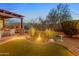 Beautiful backyard featuring a water feature, synthetic lawn, and outdoor seating area at 6887 E Hacienda La Colorada Dr, Gold Canyon, AZ 85118