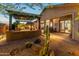Backyard with built-in barbecue area and covered patio with beautiful cacti at 6887 E Hacienda La Colorada Dr, Gold Canyon, AZ 85118