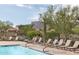 Inviting community pool featuring comfortable lounge chairs and lush desert landscaping at 6887 E Hacienda La Colorada Dr, Gold Canyon, AZ 85118