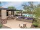 Relaxing community pool area features shaded seating, lounge chairs, and well-maintained landscaping at 6887 E Hacienda La Colorada Dr, Gold Canyon, AZ 85118