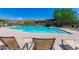 Inviting community pool area with ample lounge seating and desert mountain views at 6887 E Hacienda La Colorada Dr, Gold Canyon, AZ 85118