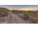 View of the desert and hiking trail with a peek at the house in the background at 6887 E Hacienda La Colorada Dr, Gold Canyon, AZ 85118