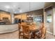 The dining area has a wooden table with chairs and has a large window for lighting at 6887 E Hacienda La Colorada Dr, Gold Canyon, AZ 85118