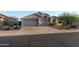 Charming home with a three-car garage and xeriscaped yard at 6887 E Hacienda La Colorada Dr, Gold Canyon, AZ 85118