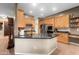 Kitchen island features a dark granite countertop and natural-toned wood cabinets at 6887 E Hacienda La Colorada Dr, Gold Canyon, AZ 85118